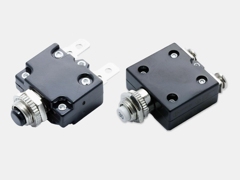 Ignition protected push-button manual reset circuit breakers with optional splashproof boot.