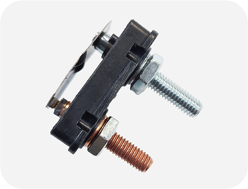 Close-up of bimetal strip in a thermal circuit breaker, bending when heated to interrupt current flow.